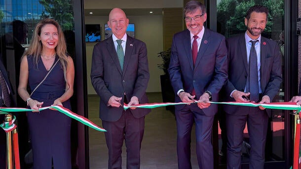 Executives cut ribbon to open a new office