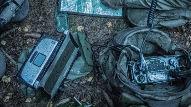 Pieces of military communications devices lie on the ground