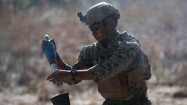 Soldier loads a round