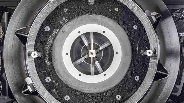 A top-down view of the OSIRIS-REx sample container with the lid removed, revealing the remainder of the asteroid sample inside. Photo: NASA/Erika Blumenfeld &amp; Joseph Aebersold
