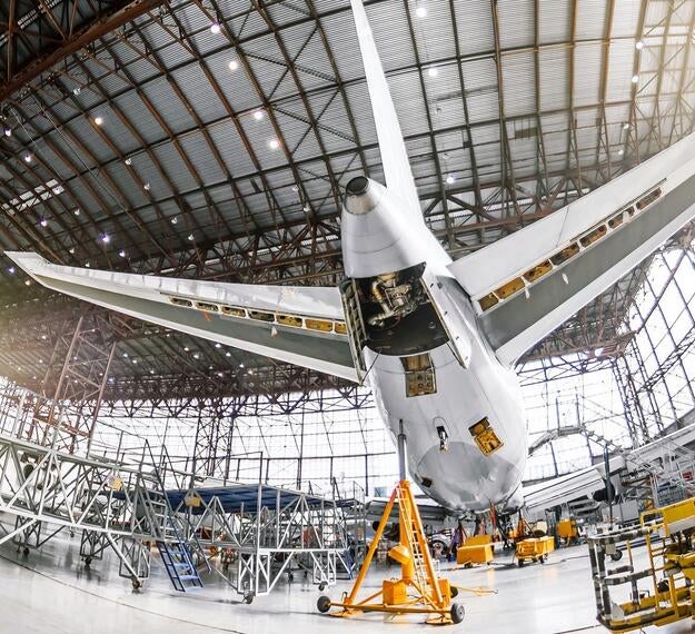 commercial aircraft in hangar undergoing maintenance