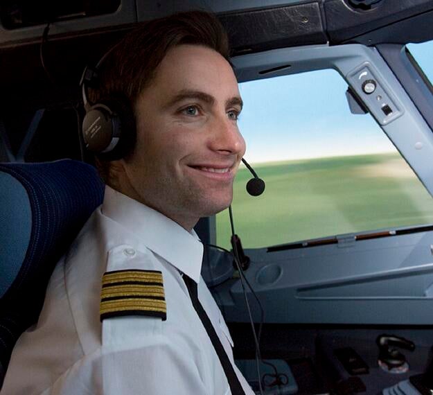 pilot smiling in cockpit
