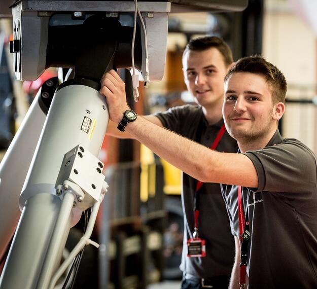 Engineers undergoing maintenance on a flight simulator