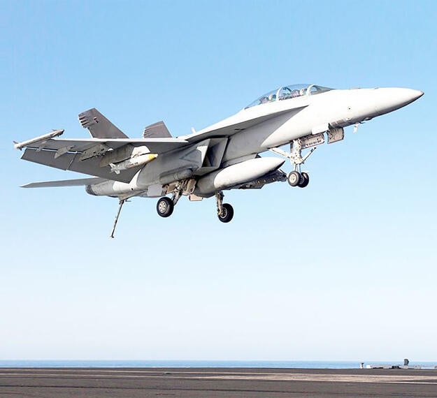 F/A-18 fighter aircraft landing on carrier