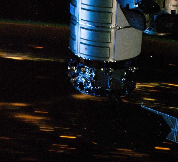 The Cygnus space freighter is pictured berthed to the International Space Station Unity module above the English Channel off the coast of France.  Image courtesy of NASA.