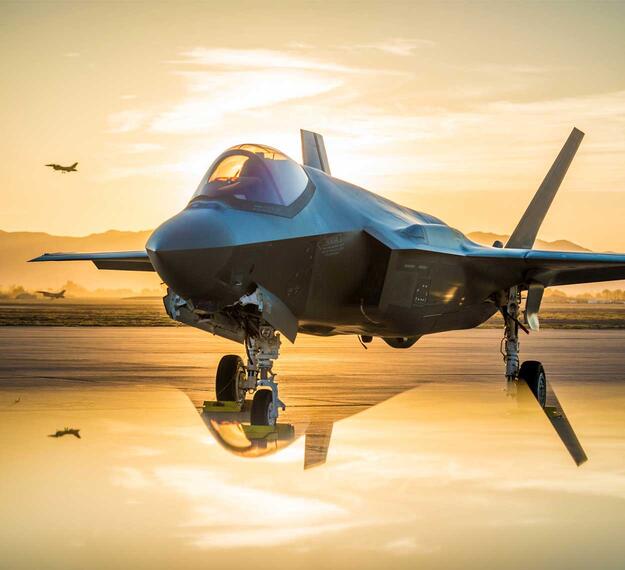 The sun sets behind an Australian F-35A Lighting II at Luke Air Force Base, Ariz., June 27, 2018. The first Australian F-35 arrived at Luke in December, 2014. Currently six Australian F-35's are assigned to the 61st Fighter Squadron where their pilots train alongside U.S. Air Force pilots. (U.S. Air Force photo by Staff Sgt. Jensen Stidham)