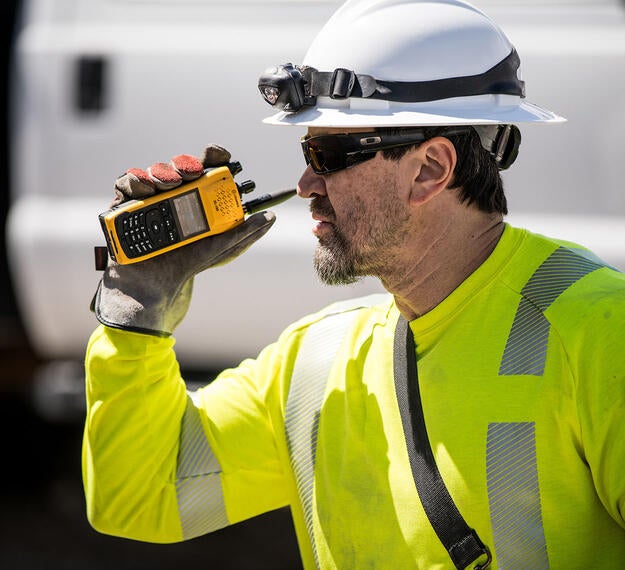 Utility worker with XL-185P LTE-ready P25 two-way radio