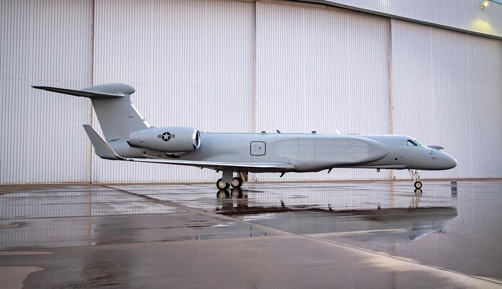 Compass Call aircraft parked outside of hangar