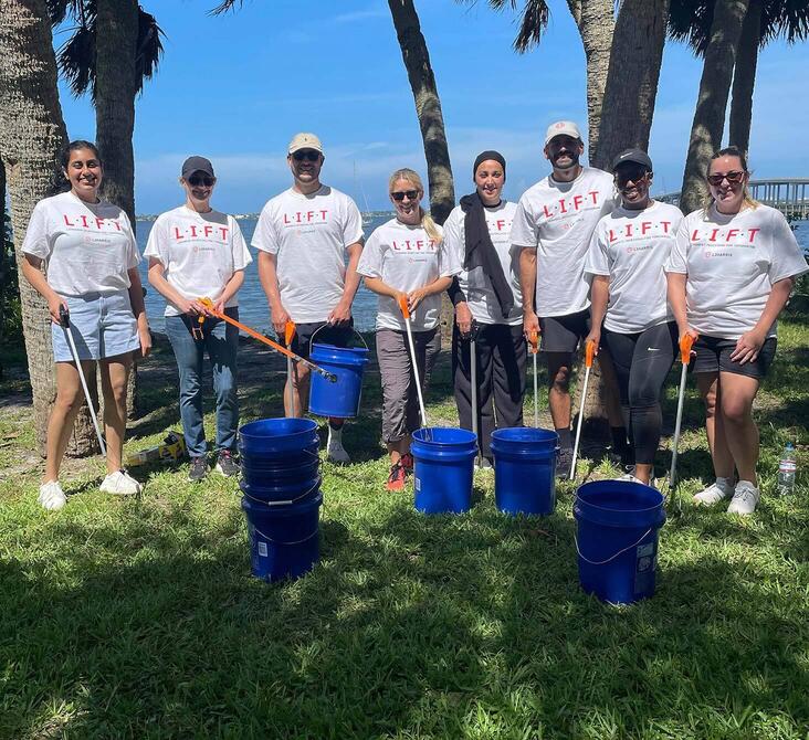Group of employees gather litter to improve their local community