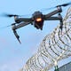 enemy drone hovering over fence