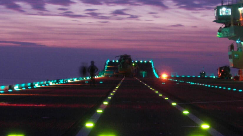 Airplane runway at night on an aircraft carrier