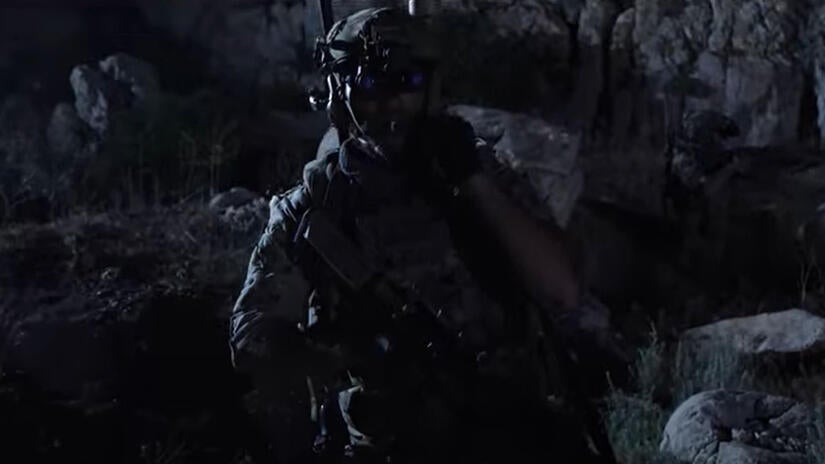 Warfighter walks through battlefield