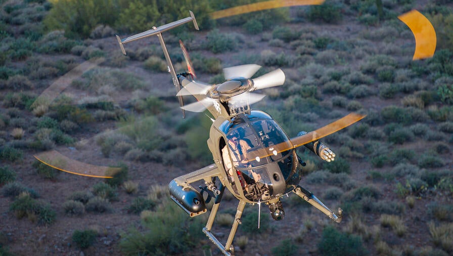 Helicopter inflight above a canopy of green trees