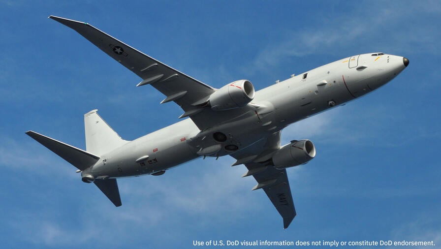 A P-8A Airplane from the U.S. Navy with WESCAM technology inflight on a clear sunny day
