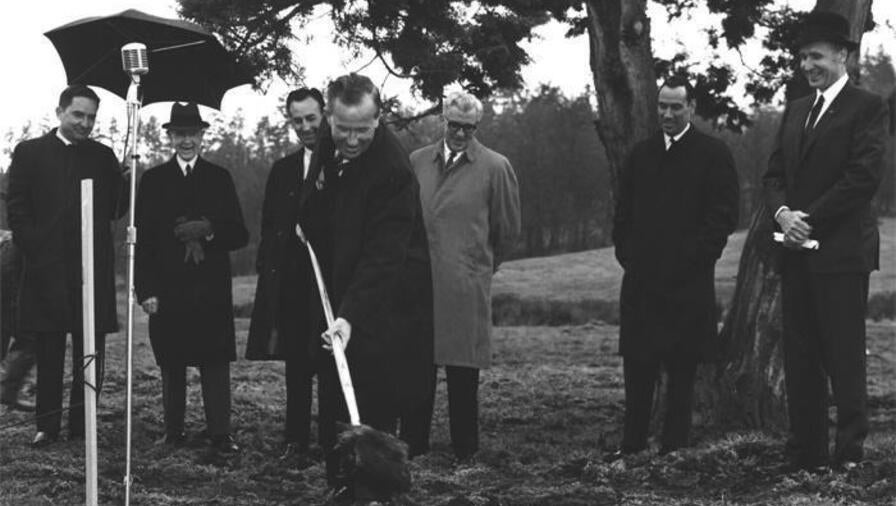 US Senator Henry M (“Scoop”) Jackson digs a shovel into the ground as others watch on