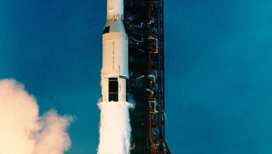 Smoke fires underneath a rocket preparing for lift-off