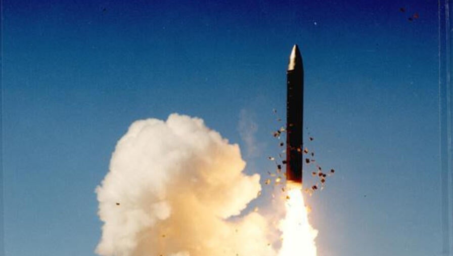A missile fires above land
