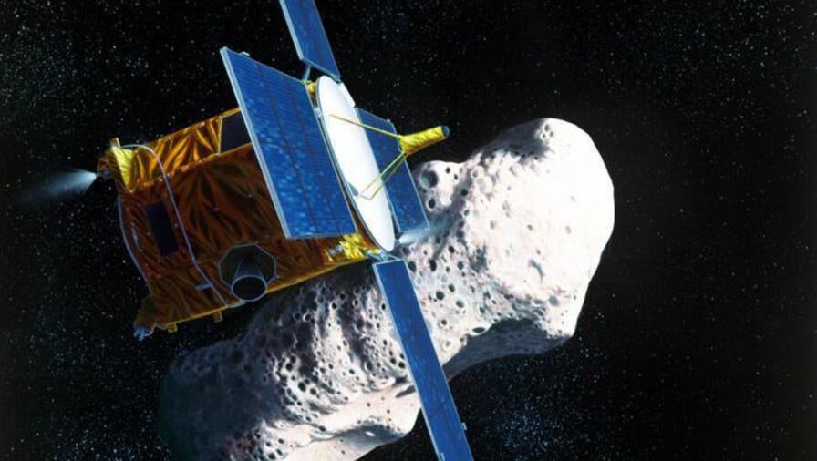 A spacecraft hovers near an asteroid in an artist rendition