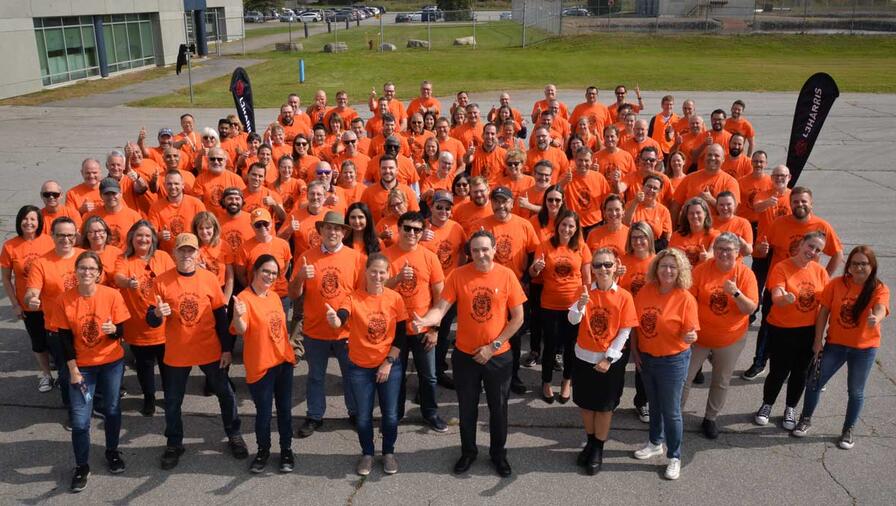 L3Harris employees in Mirabel, Quebec, proudly wore their "Mother Bear Energy" shirts on September 28, 2023.