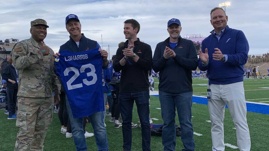 L3Harris jersey with US Air Force soldiers celebrating falcon football game