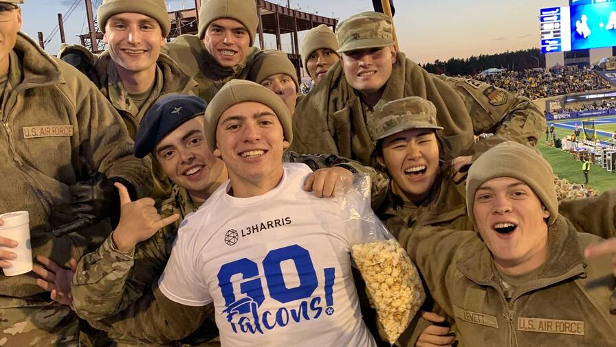 Group of US Air Force soldiers celebrating falcon football game