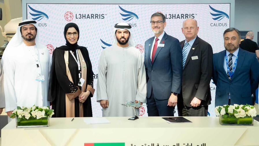 Khalifa Murad AlBlooshi, Chief Executive Officer of Calidus (center left), and David Johnson (center right), Corporate VP of L3Harris International with representatives from Calidus and L3Harris at the World Defense Show.