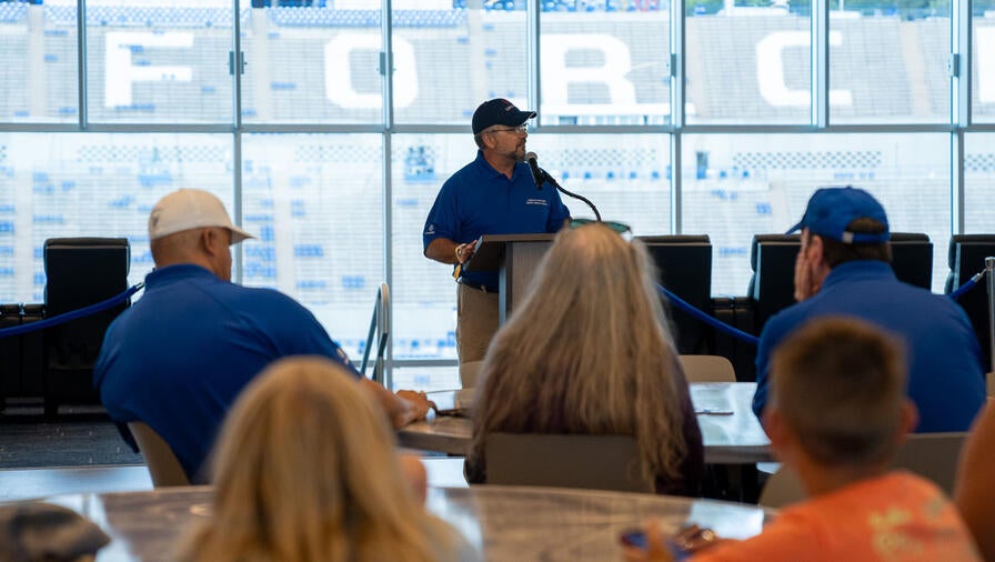 Space Defense Solutions Director Art Loureiro talks to L3Harris employees during the dedication of the East Club Presented by L3Harris at the U.S. Air Force Academy Falcon Stadium.