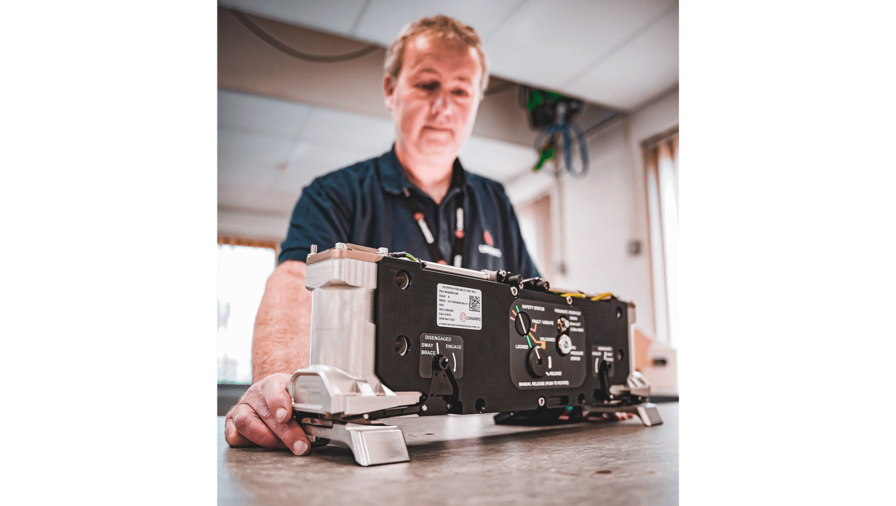 An L3Harris teammate in Brighton, U.K., examines a SCORPION release unit.