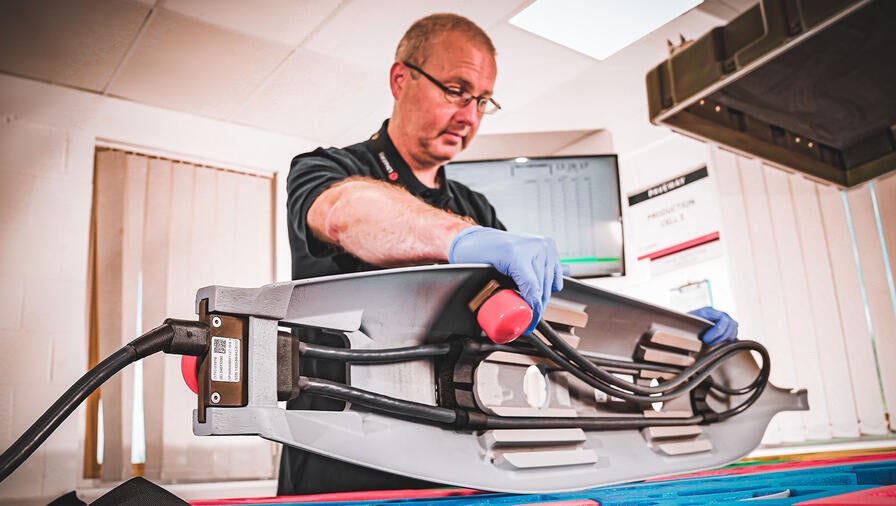 An L3Harris teammate in Brighton, U.K., kits a Paveway IV component for a customer.