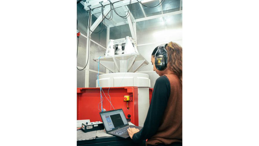 An L3Harris teammate in Brighton, U.K., monitors vibration testing of the Hornet release unit.