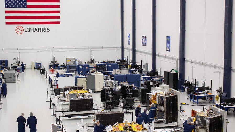 L3Harris employees work on the manufacturing floor