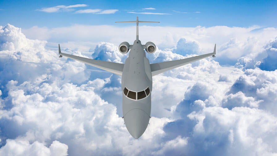 L3Harris' concept graphic of the top, front view of the AERIS X Bombardier Global 6500 Variant in flight with sky and cloud background