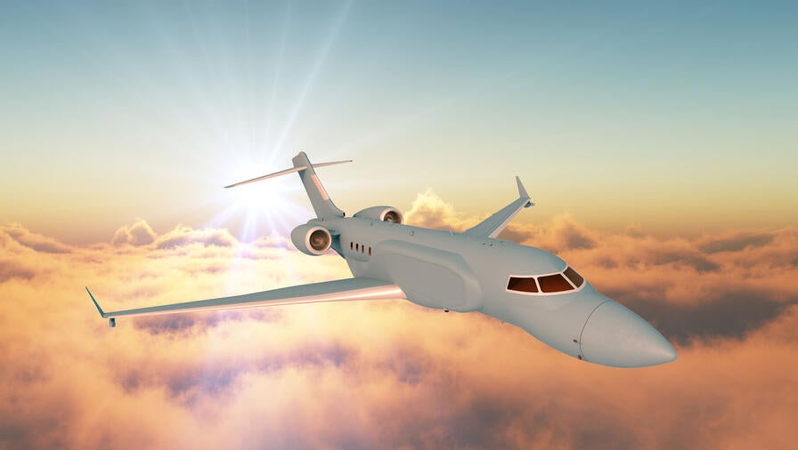 L3Harris' concept graphic of the right side, forward view of the AERIS X Bombardier Global 6500 Variant in flight with sunset sky and cloud background