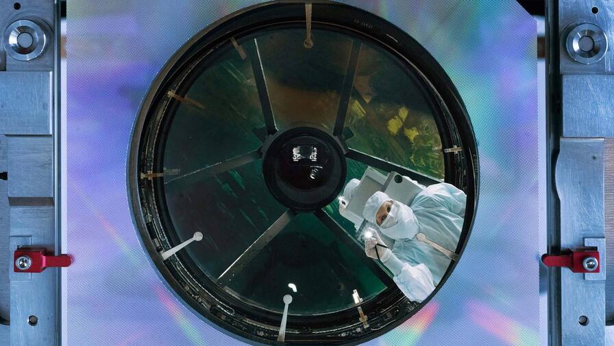 Engineer inspects NASA's Nancy Grace Roman Space Telescope's primary mirror at the L3Harris facility in Rochester, New York. Credit: NASA