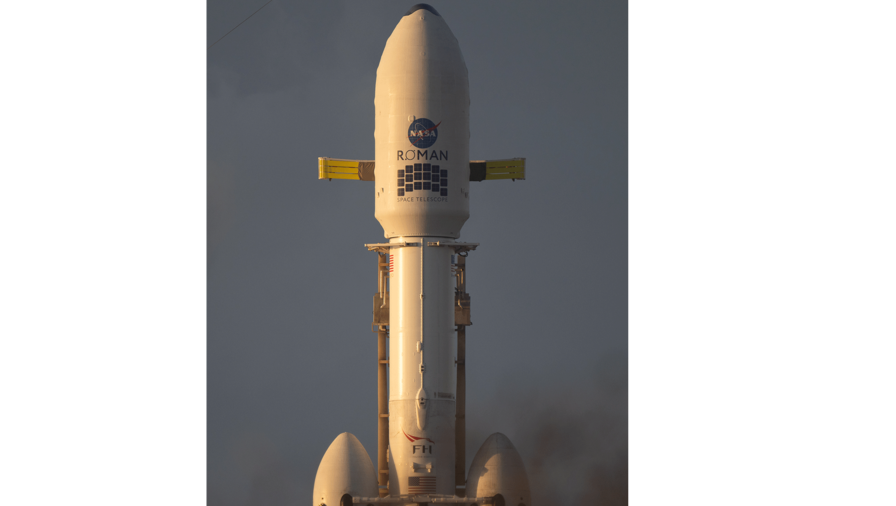 NASA’s Nancy Grace Roman Space Telescope, encapsulated in a protective payload fairing atop a SpaceX Falcon Heavy rocket, is seen at sunrise, Saturday, Aug. 29, 2026, at Launch Complex 39A at NASA’s Kennedy Space Center in Florida.